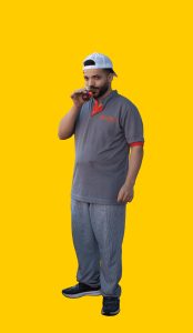 17 Gelber Hintergrund, davor ein Mensch im Portrait, der ein Glas mit Schwarztee in der Hand hält